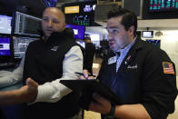 Specialist John Parisi, left, and trader Joseph Lawler work on the floor of the New York Stock Exchange, Friday, July 19, 2019. U.S. stocks moved broadly higher in early trading on Wall Street Friday and chipped away at the week's losses. (AP Photo/Richard Drew)