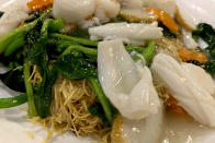 This May 24, 2019, photo shows a plate of crispy seafood noodles served at a Chinese restaurant in New York City. A social media campaign backed by a Japanese seasonings company is targeting the persistent idea that Chinese food is packed with MSG and can make you sick. So entrenched is the notion in American culture, it shows up in the dictionary: Merriam-Webster.com lists “Chinese restaurant syndrome." as a real illness. But much of the mythology around the idea has been debunked: monosodium glutamate, also known as MSG, shows up in many foods from tomatoes to breast milk, and there's no evidence to link it to illness. (AP Photo/Wong Maye-E)