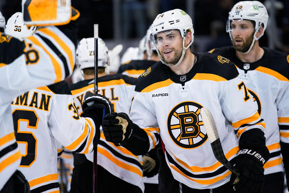 Boston Bruins defenseman Anton Stralman (36) and left wing Jake DeBrusk (74) bump fists after the team's preseason NHL hockey game against the New York Rangers, Wednesday, Oct. 5, 2022, in New York. The Bruins won 5-4. (AP Photo/Julia Nikhinson)