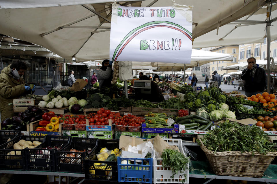 In this photo taken on Friday March 13, 2020, a banner reading "Everything will be alright" is placed at Rome's Campo Dei Fiori market. The nationwide lockdown to slow coronavirus is still early days for much of Italy, but Italians are already are showing signs of solidarity. This week, children’s drawings of rainbows are appearing all over social media as well as on balconies and windows in major cities ready, ‘’Andra’ tutto bene,’’ Italian for ‘’Everything will be alright.’’ For most people, the new coronavirus causes only mild or moderate symptoms. For some, it can cause more severe illness, especially in older adults and people with existing health problems. (AP Photo/Alessandra Tarantino)