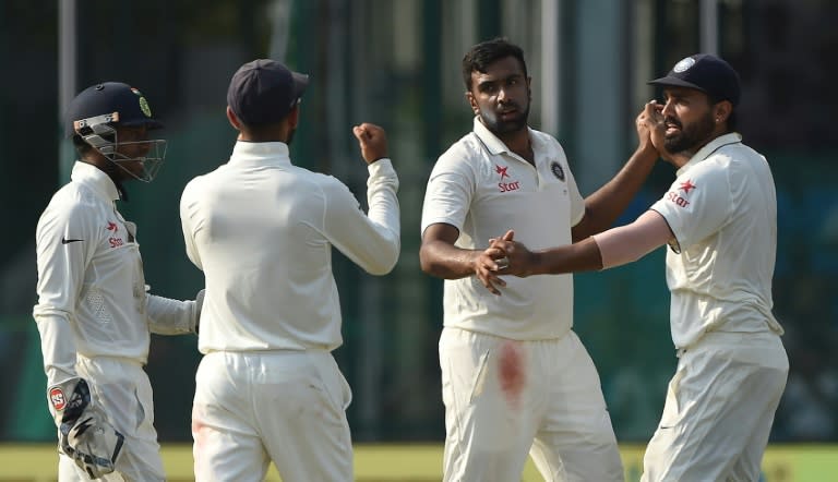 India's Ravichandran Ashwin (2nd right) celebrates the wicket of New Zealand's captain Kane Williamson during the fourth day of the first Test match between India and New Zealand in Kanpur on September 25, 2016