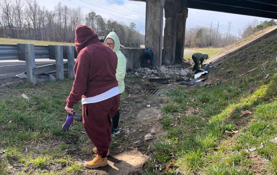 Alyssa Taylor’s cousins search under the N.C. 86 bridge in Hillsborough, where the truck in which the Virginia woman was riding crashed and burned in September 2022. The driver was recovered from the site along Interstate 85, but Alyssa was never found.