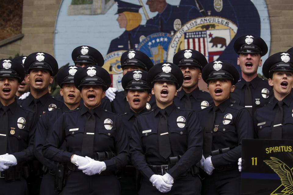 New graduates sing their class chant after a graduation ceremony.