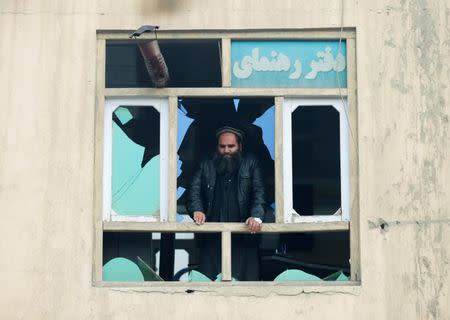 FILE PHOTO: An Afghan man looks out the broken window at the site of a car bomb attack in Kabul, Afghanistan, November 29, 2018. REUTERS/Mohammad Ismail/File Photo