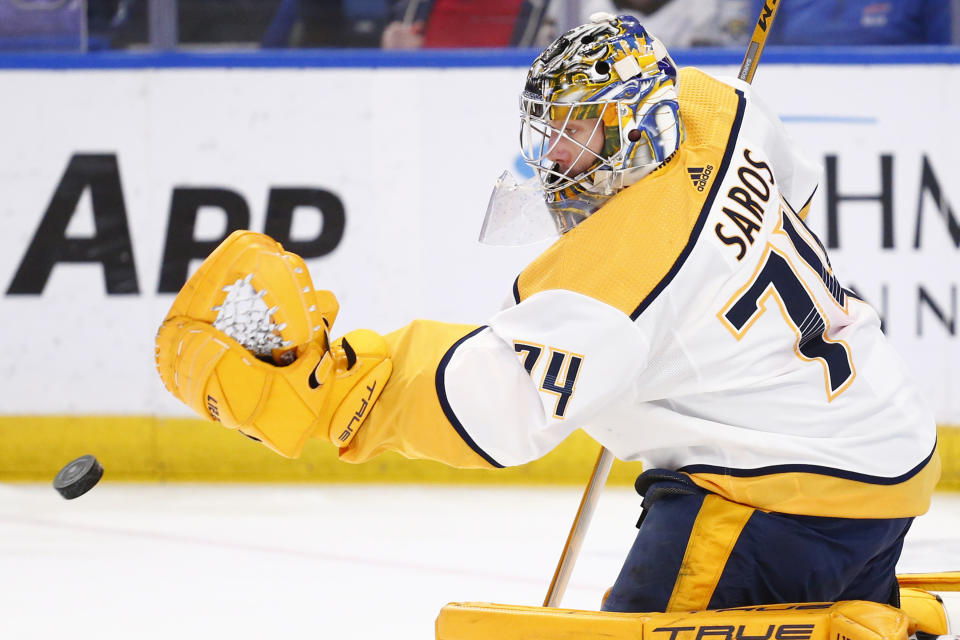 Nashville Predators goaltender Juuse Saros (74) makes a glove-save during the first period of an NHL hockey game against the Buffalo Sabres, Friday, April 1, 2022, in Buffalo, N.Y. (AP Photo/Jeffrey T. Barnes)