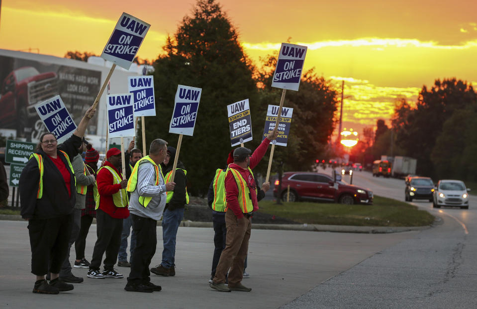 File - UAW local 862 members strike outside of Ford's Kentucky Truck Plant in Louisville, Ky. on Oct. 12, 2023. In each new contract between the United Auto Workers union and General Motors, Ford and Stellantis, parts of the companies' secret long-term plans for new vehicles are exposed. (Michael Clevenger/Courier Journal via AP, File)