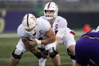 Stanford center Drew Dalman, left, snaps the ball to quarterback Davis Mills in the second half of an NCAA college football game against Washington, Saturday, Dec. 5, 2020, in Seattle. (AP Photo/Elaine Thompson)