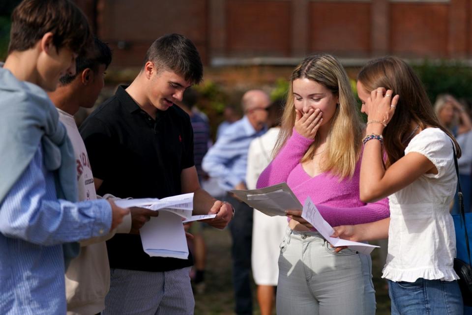 Anna Austin (centre-right) reacts when reading their A-level results at Norwich School, Norwich. (PA)