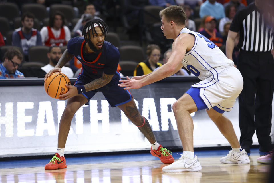 Duquesne guard Dae Dae Grant (3) is guarded by BYU guard Dallin Hall (30) in the first half of a first-round college basketball game in the NCAA Tournament, Thursday, March 21, 2024, in Omaha, Neb. (AP Photo/John Peterson)