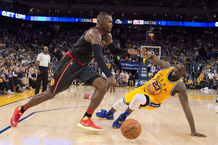 March 1, 2016; Oakland, CA, USA; Atlanta Hawks forward Paul Millsap (4) dribbles the basketball against Golden State Warriors forward Draymond Green (23) during the fourth quarter at Oracle Arena. Mandatory Credit: Kyle Terada-USA TODAY Sports