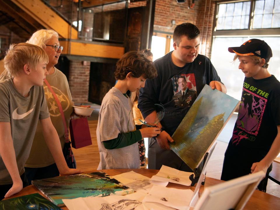 Gavin Conner talks about his paintings during the Acton Children's Business Fair at the Mill & Mine.