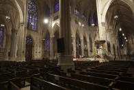 FILE - In this Sunday, April 12, 2020 file photo, Cardinal Timothy Dolan, right, delivers his homily over mostly empty pews as he leads an Easter Mass at St. Patrick's Cathedral in New York. Due to coronavirus concerns, no congregants were allowed to attend the Mass which was broadcast live on local TV. The Archdiocese of New York received 15 loans worth at least $28 million just for its top executive offices. St. Patrick’s Cathedral on Fifth Avenue was approved for at least $1 million. (AP Photo/Seth Wenig)