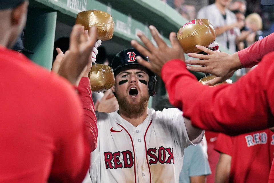 Boston Red Sox's Christian Arroyo celebrates in the dugout after his solo home run in the seventh inning during a baseball game against the Colorado Rockies at Fenway Park, Monday, June 12, 2023, in Boston. (AP Photo/Charles Krupa)