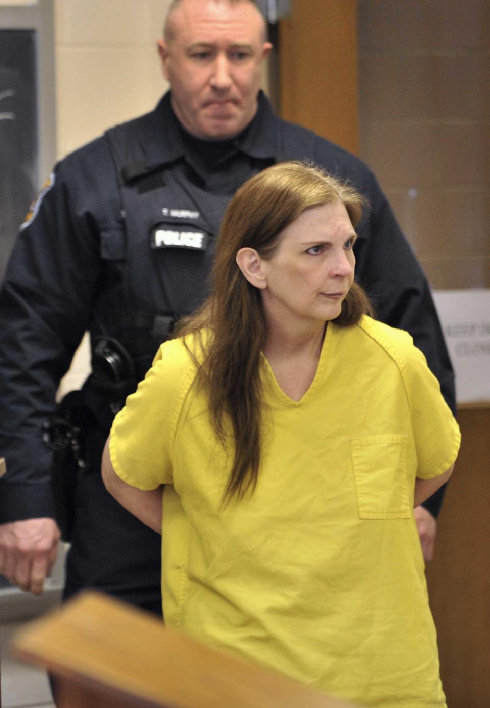 Defendant Donna Scrivo enters the courtroom. for her arraignment at 40th District Court in St. Clair Shores, Mich. on Monday, Feb. 3, 2014. Scrivo is charged with mutilating and illegally removing a corpse after her 32-year-old son's body parts were found in bags along two rural roadways. (AP Photo/Detroit News, Robin Buckson) DETROIT FREE PRESS OUT; HUFFINGTON POST OUT