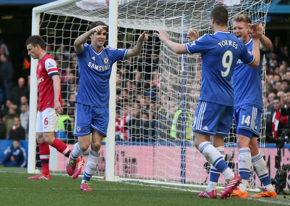 Chelsea's Oscar, 2nd left, celebrates after scoring his side's 4th goal of the game during their English Premier League soccer match between Chelsea and Arsenal at Stamford Bridge stadium in London, Saturday, March, 22, 2014. (AP Photo/Alastair Grant)