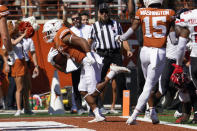 Texas running back Roschon Johnson (2) runs for a touchdown against Texas Tech during the first half of an NCAA college football game on Saturday, Sept. 25, 2021, in Austin, Texas. (AP Photo/Chuck Burton)