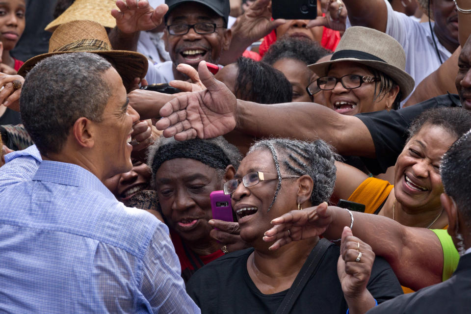 FILE - In this July 14, 2012, file photo President Barack Obama campaigns under the pouring rain at the historic Walkerton Tavern & Gardens in Glen Allen, Va., near Richmond. Four months from Election Day, Obama has an edge in support among women, African-Americans, Hispanics and young people, groups that could him swing the race in November. (AP Photo/J. Scott Applewhite, File)