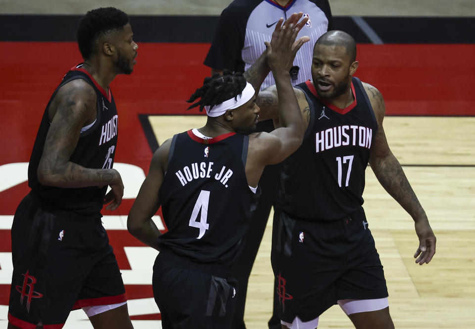 Danuel House Jr. and P.J. Tucker high five after a play.