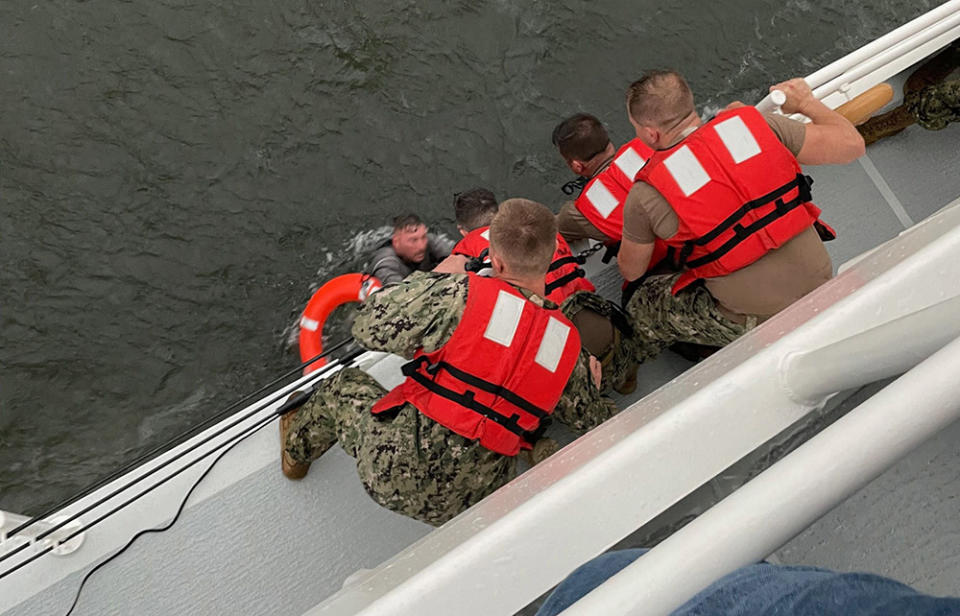 Image: The crew of the Coast Guard Cutter Glenn Harris pull a person from the water (U.S. Coast Guard / AFP - Getty Images)