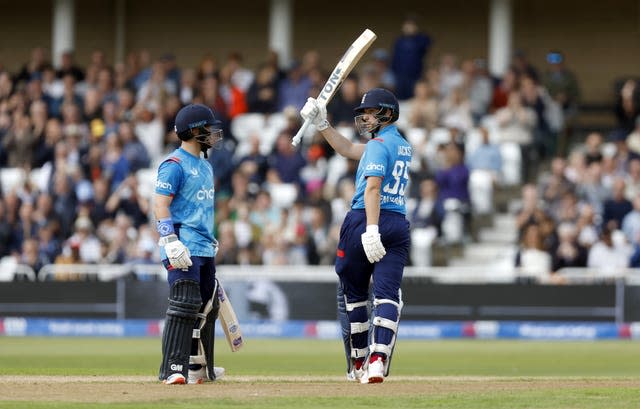 England's Will Jacks raises his bat to mark an ODI half-century against Australia as Harry Brook looks on.