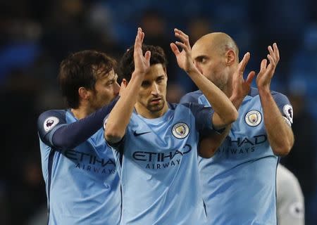 Britain Football Soccer - Manchester City v Watford - Premier League - Etihad Stadium - 14/12/16 (L - R) Manchester City's David Silva, Jesus Navas and Pablo Zabaleta celebrate after the game Reuters / Phil Noble Livepic