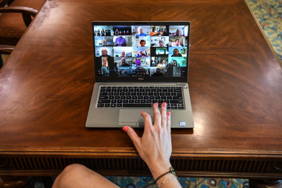 Manager of communications Jamisyn Becker, 33, sets up a Zoom chat for a virtual birthday party celebration in John Knox Village, a retirement community in Pompano Beach some 40 miles north of Miami, Florida on August 7, 2020. - About 900 retirees live in the John Knox Village senior community in Pompano Beach, South Florida. Of these, about 400 have learned to use technology to order food to their apartments, communicate with each other or participate in online social activities. Thirty of them participate in a book club over Zoom since the pandemic began. Florida, a coronavirus hotspot with nearly 8,000 deaths, is the US state with the highest proportion of elderly people, which is also the population most vulnerable to the disease. 20% of its 21 million inhabitants are over 65, according to a 2019 Population Reference Bureau study. (Photo by CHANDAN KHANNA / AFP) (Photo by CHANDAN KHANNA/AFP via Getty Images)