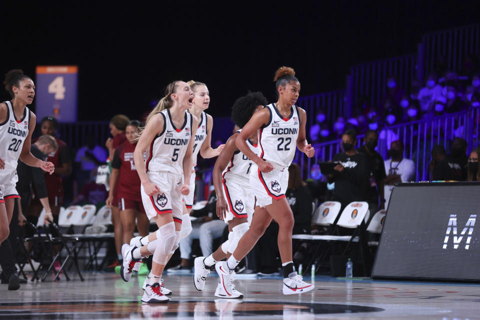 In this photo provided by Bahamas Visual Services, UConn's Paige Bueckers (5) and teammates including Olivia Nelson-Ododa (20), far left, and Evina Westbrook (22), right, react during an NCAA college basketball game against South Carolina at Paradise Island, Bahamas, Monday, Nov. 22, 2021. (Tim Aylen/Bahamas Visual Services via AP)