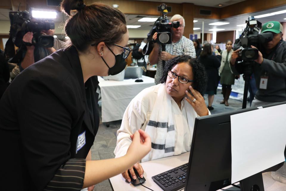 Ella Azoulay of the Student Borrower Protection Center helps Giselle Morton of East Bridgewater, Massachusetts, with her student debt loan at Massasoit Community College in October.