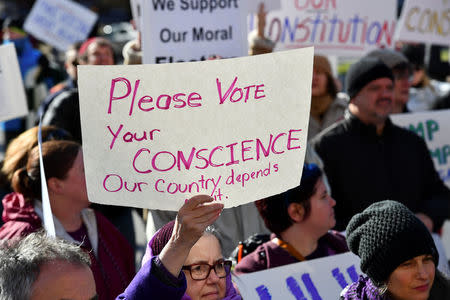 Activists demonstrate against U.S. President-elect Donald Trump ahead of the meeting of the Electoral College at the Texas State Capitol in Austin, Texas, U.S. December 19, 2016. REUTERS/Mohammad Khursheed