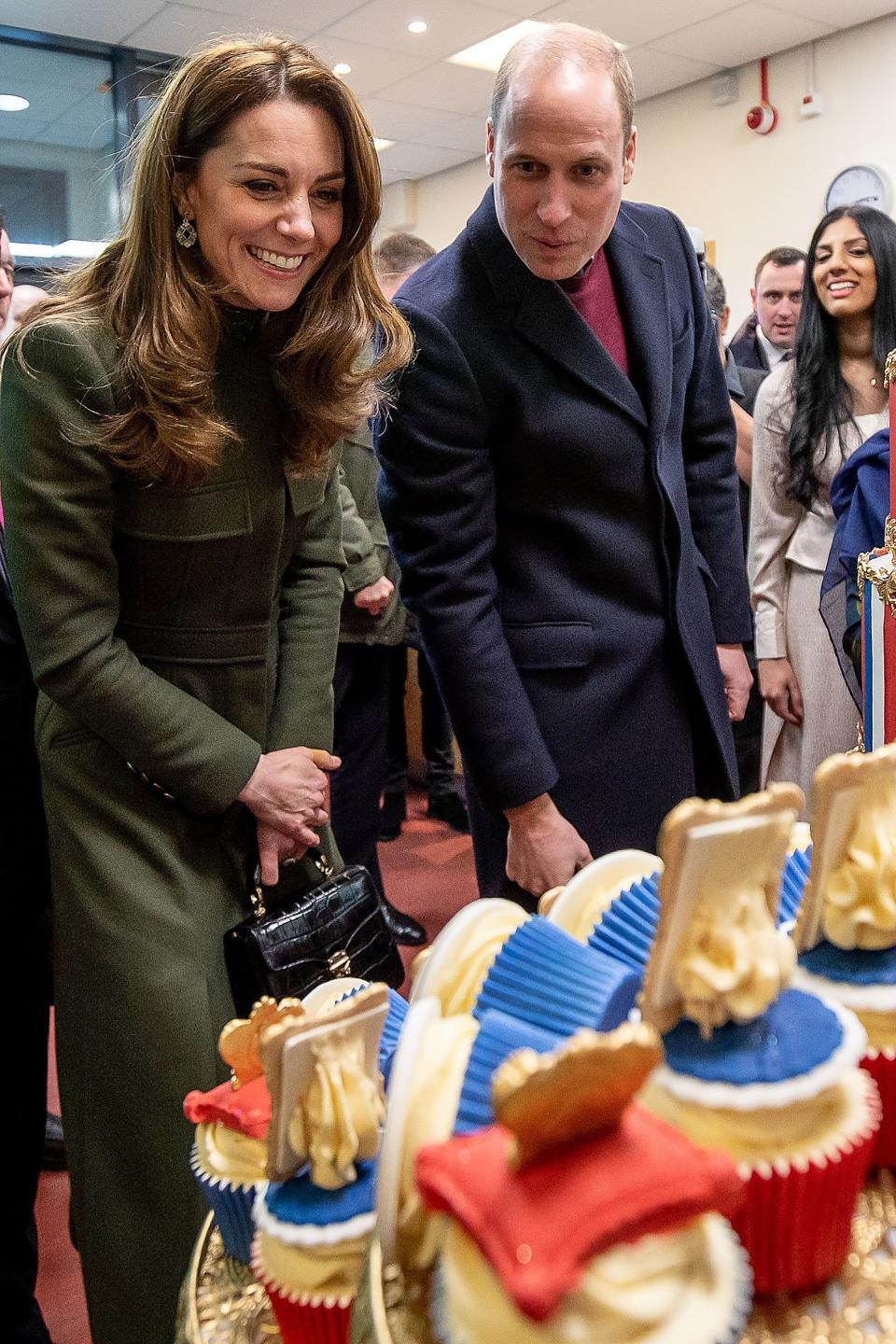 Britain's Prince William, Duke of Cambridge and Britain's Catherine, Duchess of Cambridge react during their visit to the Khidmat Centre in Bradford on January 15, 2020, to learn about the activities and workshops offered by the centre. (Photo by Charlotte Graham / POOL / AFP) (Photo by CHARLOTTE GRAHAM/POOL/AFP via Getty Images)
