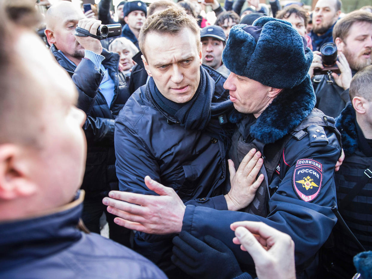 Police officers detaining Kremlin critic Alexei Navalny during an unauthorised anti-corruption rally in central Moscow: AFP/Getty Images