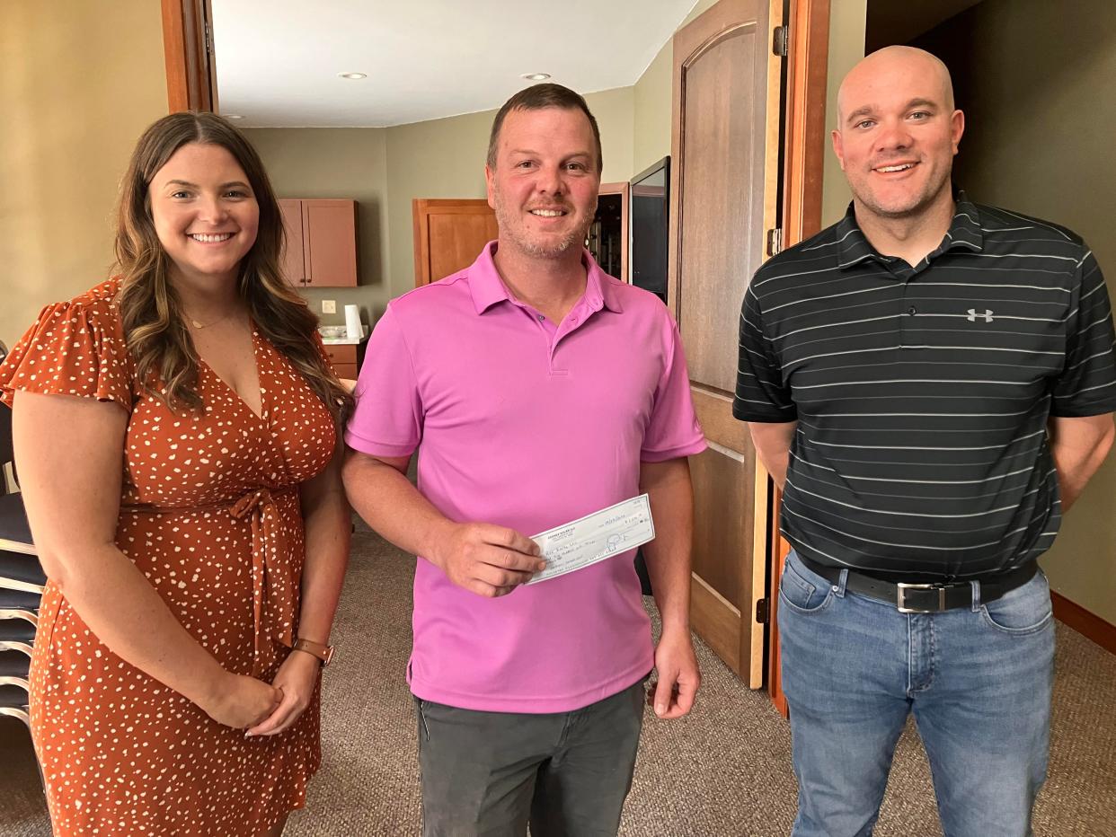 Jared Miller, center, owner of Fair Price Realty, received a grant from Wombat Solar to help mitigate the effects of the storm on his properties. His is shown with Leah Cordy and Wes Smith of Wombat Solar.