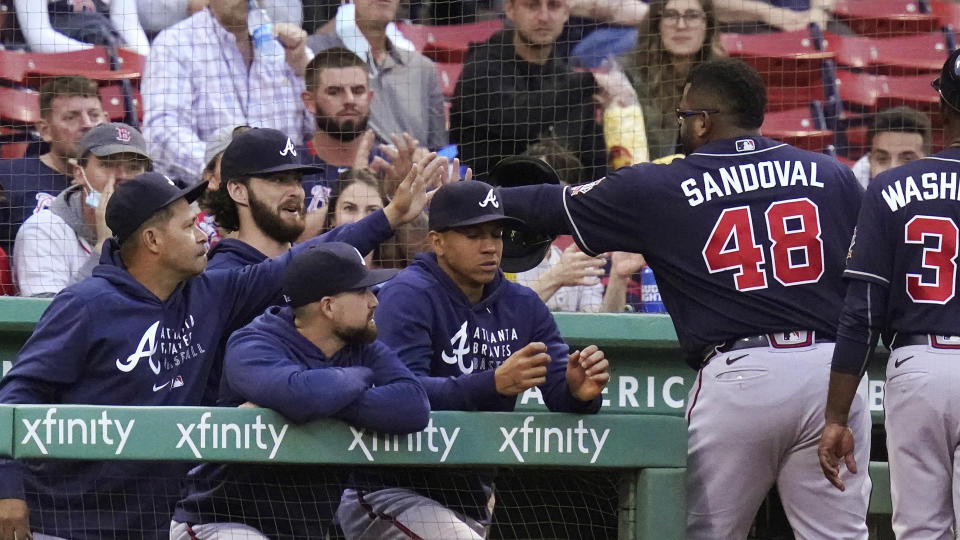 Atlanta Braves' Pablo Sandoval (48) is congratulated by teammates after the top of the second inning of the team's baseball game against the Boston Red Sox at Fenway Park, Tuesday, May 25, 2021, in Boston. Sandoval singled in the inning. (AP Photo/Charles Krupa)
