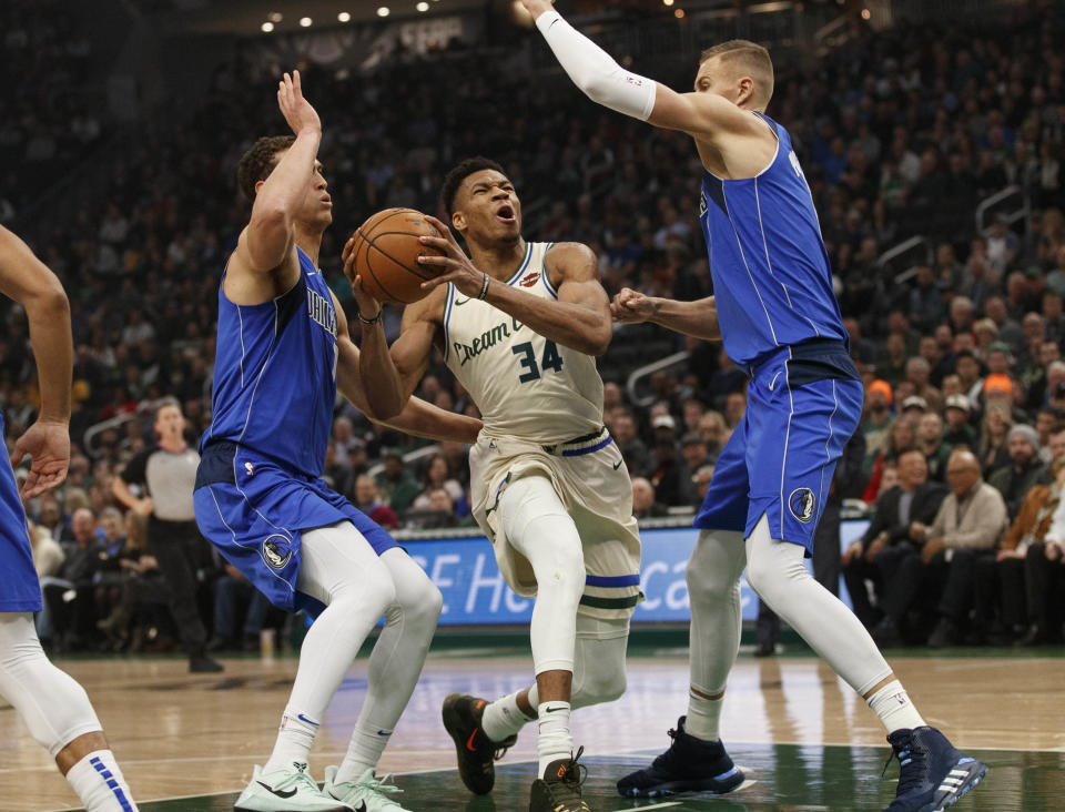 With Luka Doncic injured, Kristaps Porzingis, right, led Dallas to a big upset in Milwaukee. (Jeff Hanisch-USA Today)