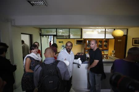 An Israeli (C) survivor from the blizzard with frostbitten hands walks out from the hospital after being discharged in Kathmandu October 18, 2014. REUTERS/Navesh Chitrakar