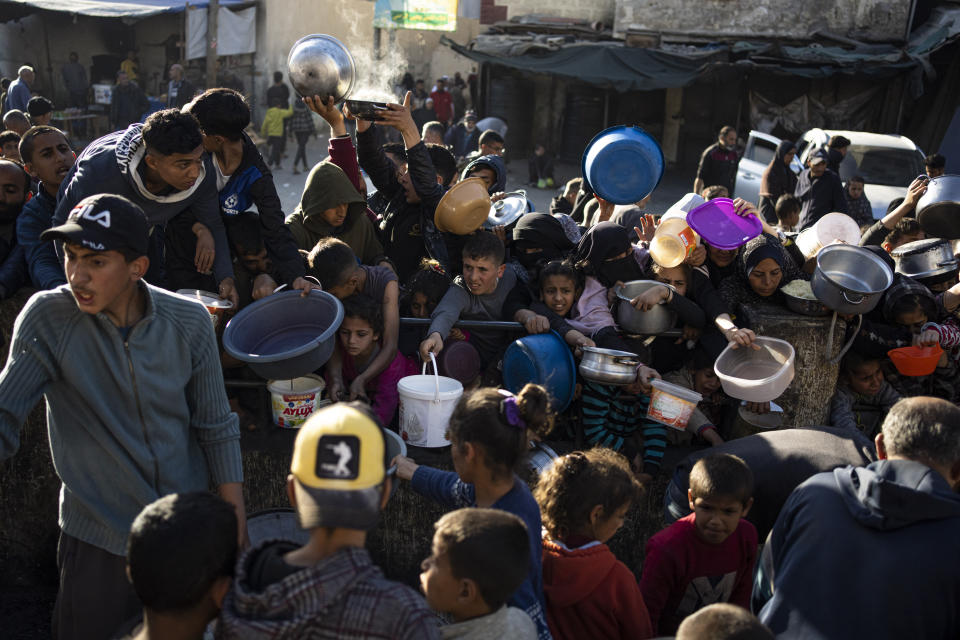 Palestinians line up for a free meal in Rafah, Gaza Strip, on Tuesday, March 12, 2024. (AP Photo/Fatima Shbair)