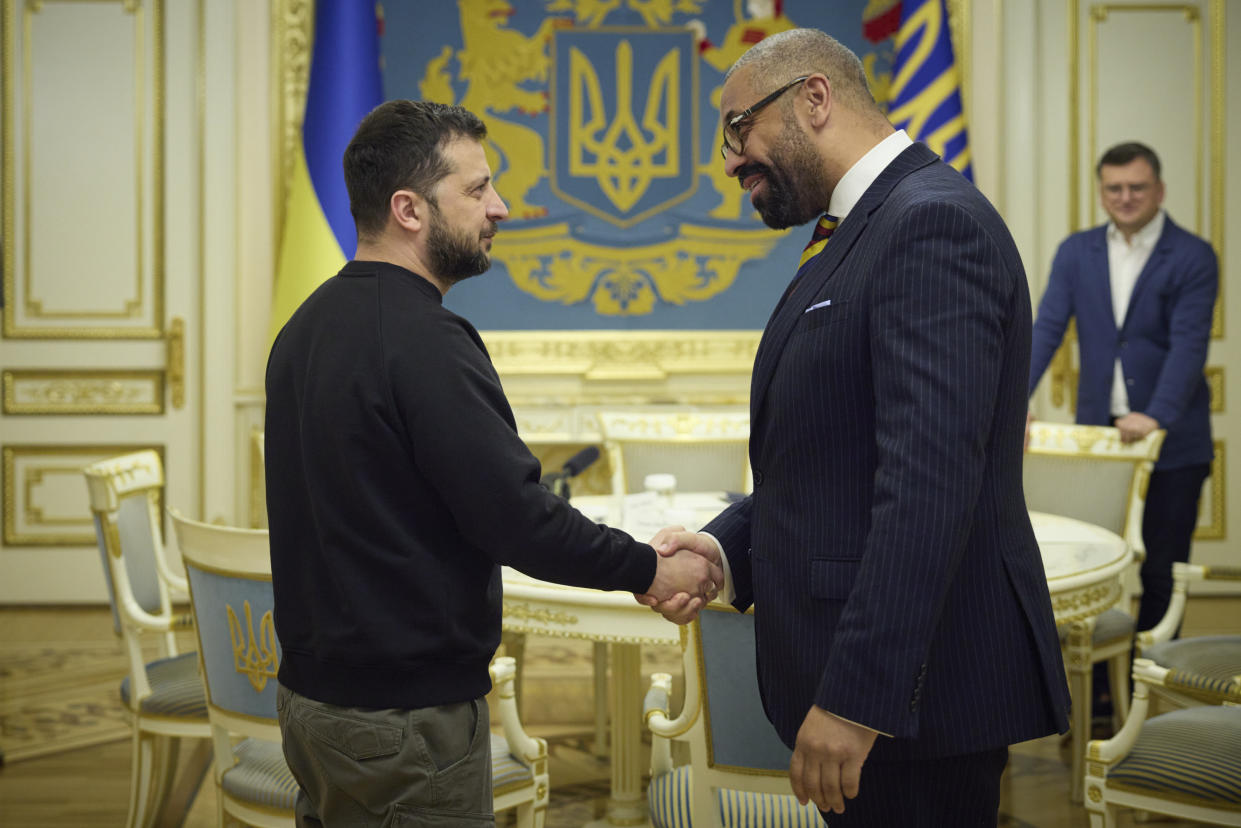 Volodymyr Zelensky, left, shakes hands with British Foreign Secretary James Cleverly