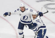 Tampa Bay Lightning left wing Yanni Gourde (37) celebrates his goal against the Dallas Stars with Ondrej Palat (18) during the second period of Game 4 of the NHL hockey Stanley Cup Final, Friday, Sept. 25, 2020, in Edmonton, Alberta. (Jason Franson/The Canadian Press via AP)