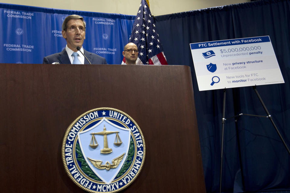 Federal Trade Commission FTC Chairman Joe Simons accompanied by Noah Joshua Phillips speaks during a news conference about Facebook settlement at FTC headquarters in Washington, Wednesday, July 24, 2019. (AP Photo/Jose Luis Magana)