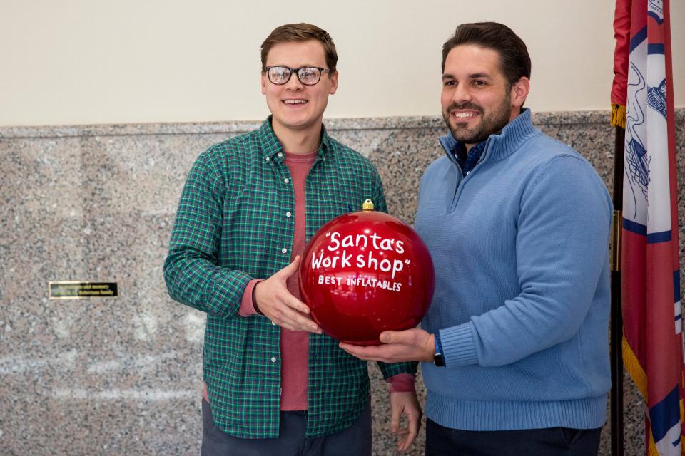 Grant Robbins is presented with the “Santa’s Workshop” award for best inflatables for the Light Up Jackson contest by Mayor Scott Conger on Monday, January 9, 2023, at city hall in Jackson, Tenn.