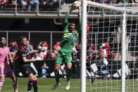 Inter Miami goalkeeper Drake Callender reaches for a high cross during the first half of an MLS soccer match against DC United at Audi Field, Saturday, March 16, 2024, in Washington. (AP Photo/Nathan Howard)