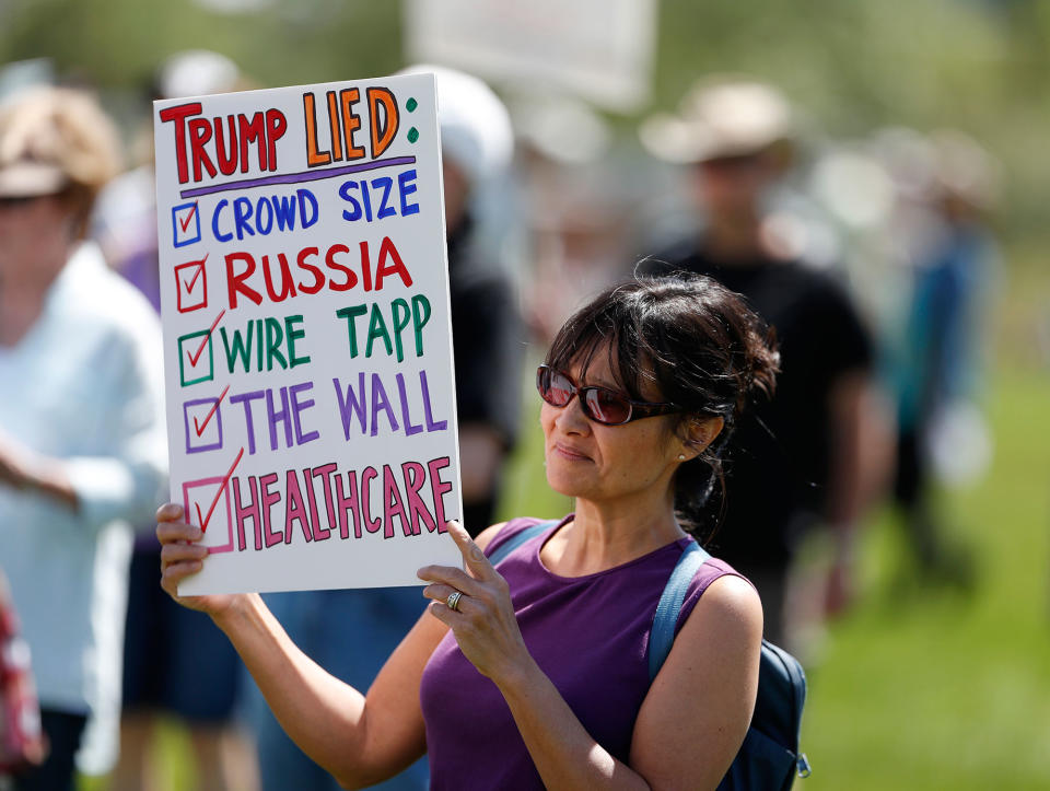 <p>Fe Baron of Boulder, Colo., holds up a sign during a protest against the polices of President Donald Trump Saturday, June 3, 2017, in downtown Denver. (Photo: David Zalubowski/AP) </p>