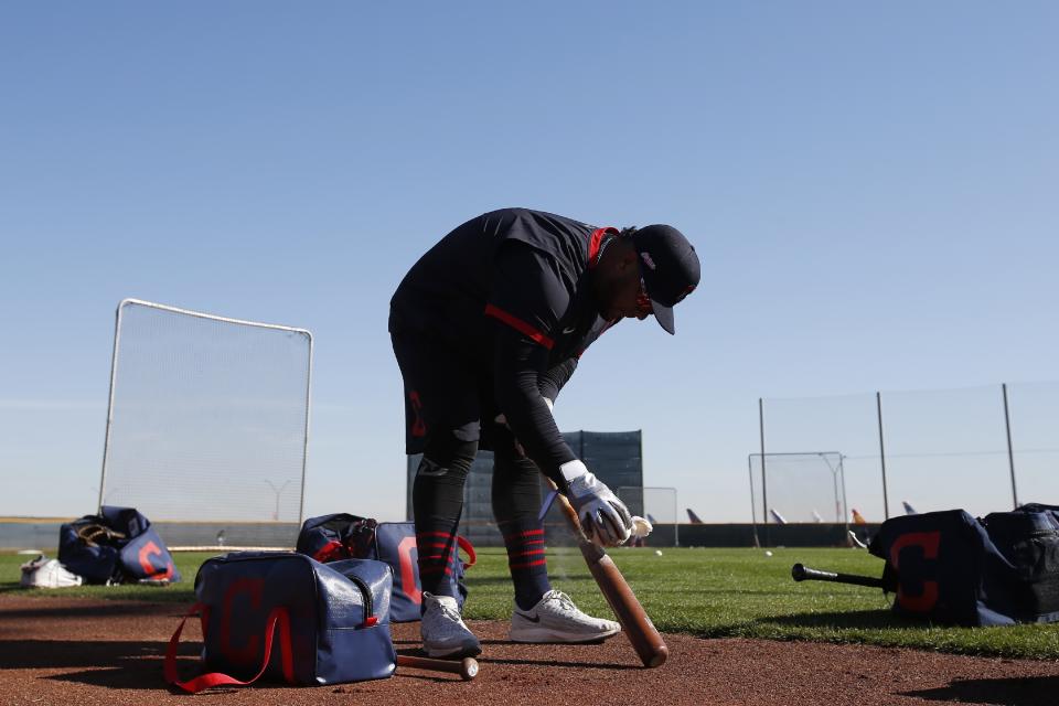 Cleveland Indians' Wilson Garcia gets a bat ready as early arrival position players take batting practice during spring training baseball workouts Friday, Feb. 14, 2020, in Avondale, Ariz. (AP Photo/Ross D. Franklin)