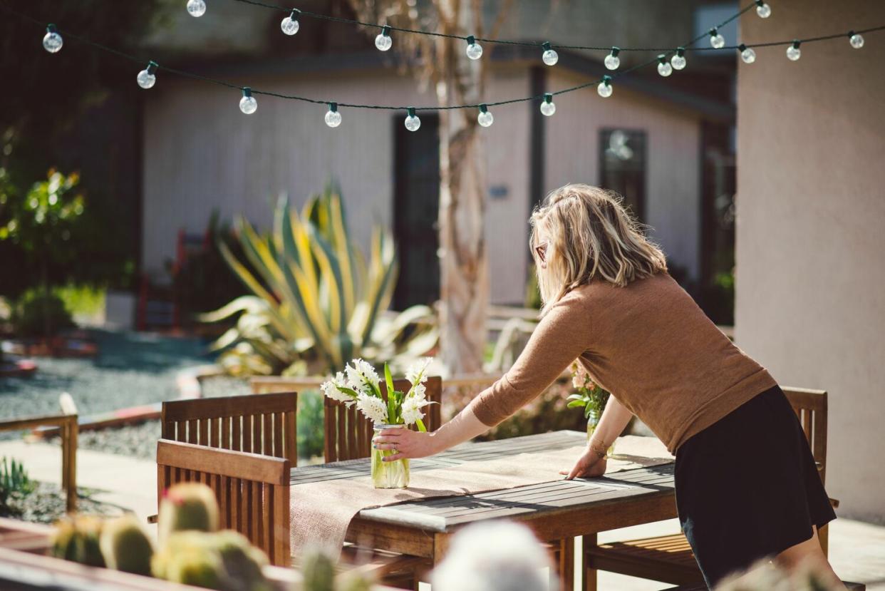 woman setting table outside