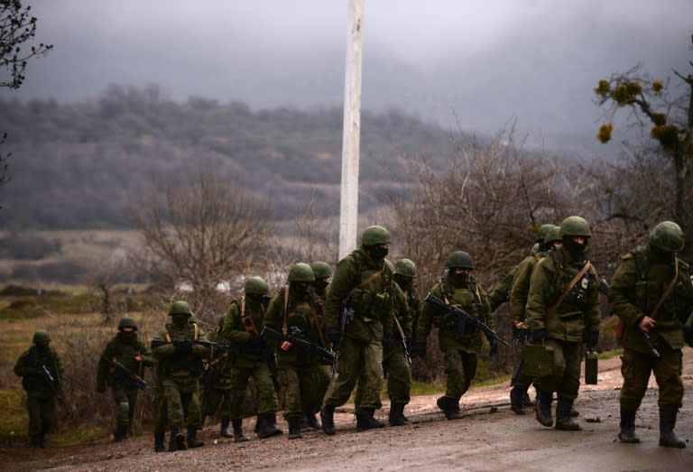 Russian soldiers patrol the area surrounding the Ukrainian military unit in Perevalnoye, outside Simferopol, on March 20, 2014