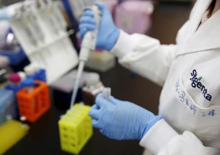 A researcher uses a pipette to develop assay to detect specific gene of corn at a lab in Syngenta Biotech Center in Beijing, China, in this February 19, 2016 file photo. REUTERS/Kim Kyung-Hoon/Files