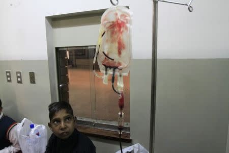 A boy suffering from Thalassemia looks on as he undergoes a blood transfusion process at Pakistan Institute of Medical Sciences (PIMS) in Islamabad December 5, 2014. REUTERS/Faisl Mahmood