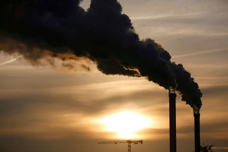 FILE PHOTO: Water vapour billows from smokestacks at the incineration plant of Ivry-sur-Seine, near Paris as the sun rises, France, December 9, 2016. REUTERS/Charles Platiau/File Photo