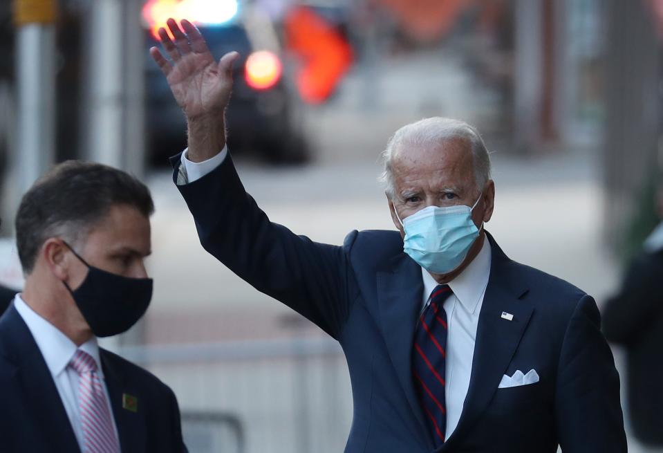 President-elect Joe Biden waves as he leaves the Queen Theater after receiving a briefing on national security with advisors on Tuesday in Wilmington, Delaware.