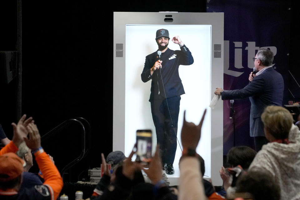 Chicago Bears first-round draft pick Caleb Williams is interviewed, via a holographic projection, by Bears play-by-play announce Jeff Joniak during the team's NFL football draft party at Soldier Field on Thursday, April 25, 2024, in Chicago. (AP Photo/Charles Rex Arbogast)